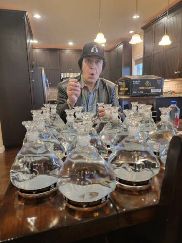 Gene Simmons with Moneybag Vodka bottles